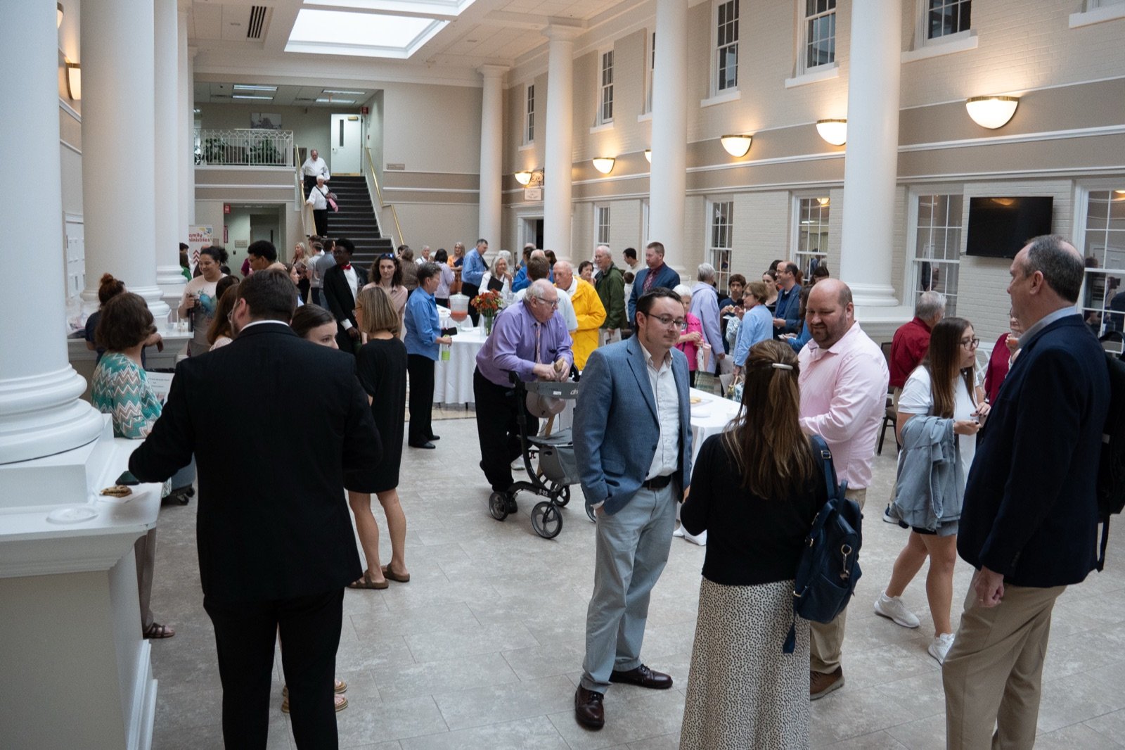 Members of Dalton First gathered and talking together in the church atrium after a service